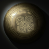 Decorative gold sphere with intricate patterns on a dark background